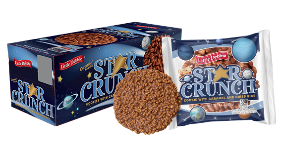 A Star Crunch Cookie in a wrapper with planets and stars on the packaging. A single, unwrapped crispy, caramel and chocolate cookie is beside the wrapper. A carton of cookies is in the background.